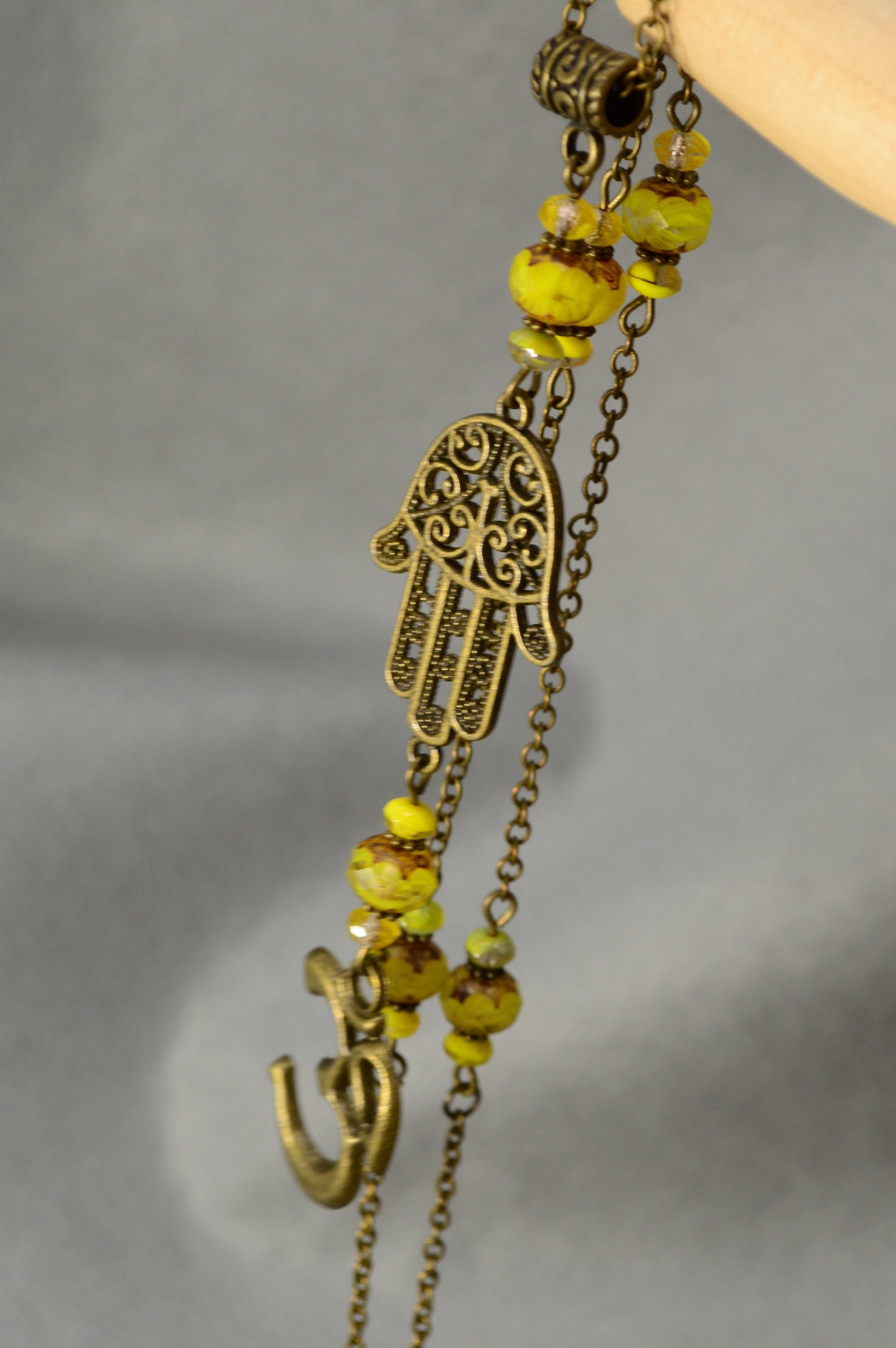 Golden Aura: Bronze Chain Necklace Adorned with Yellow Glass Beads and Spiritual Pendants