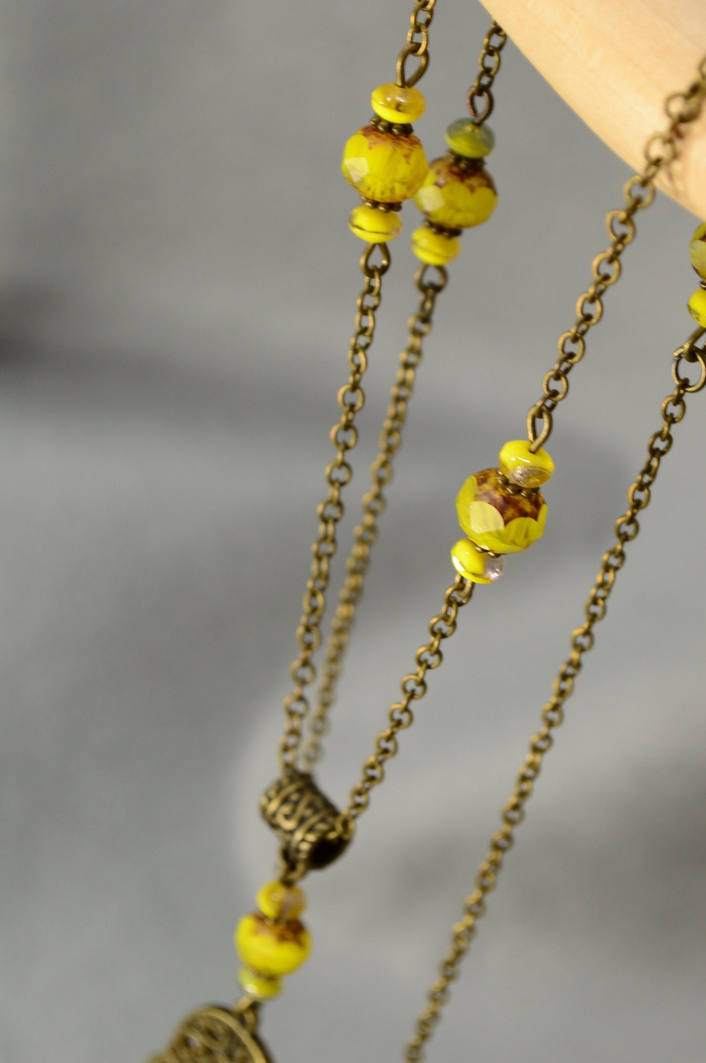 Golden Aura: Bronze Chain Necklace Adorned with Yellow Glass Beads and Spiritual Pendants
