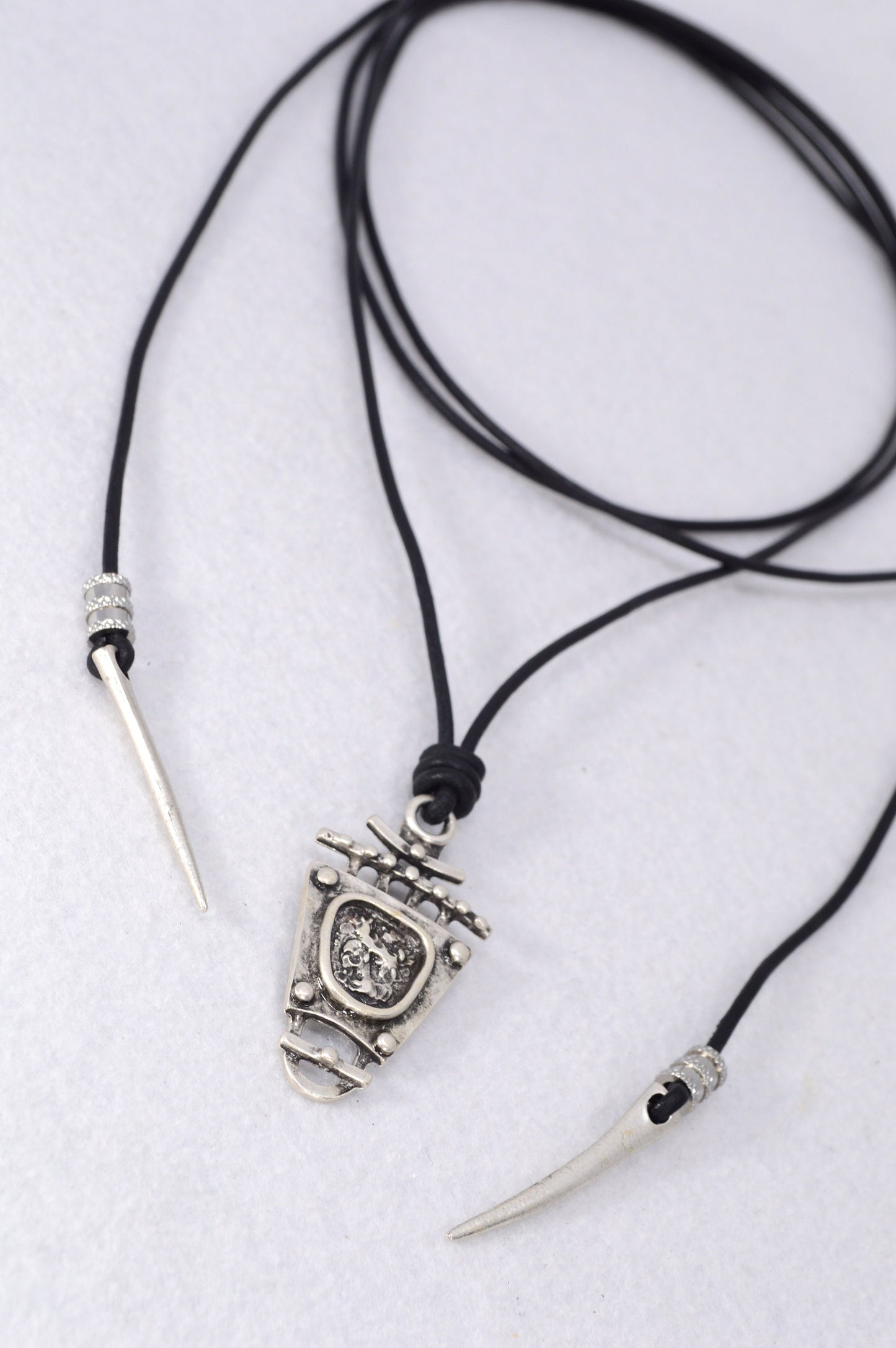 Tribal boho pendant. Black leather cord necklace trends. Boho chic accessory for women. Estibela design.