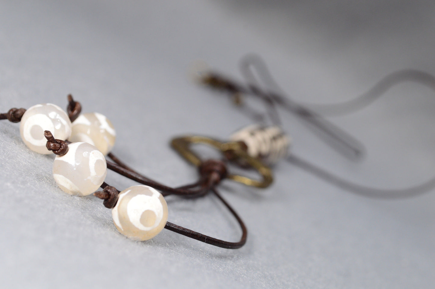 Long Leather cord necklace with agate DZI bead design, Artisan-crafted hippie Ring pendant, tribal-inspired. Estibela design.