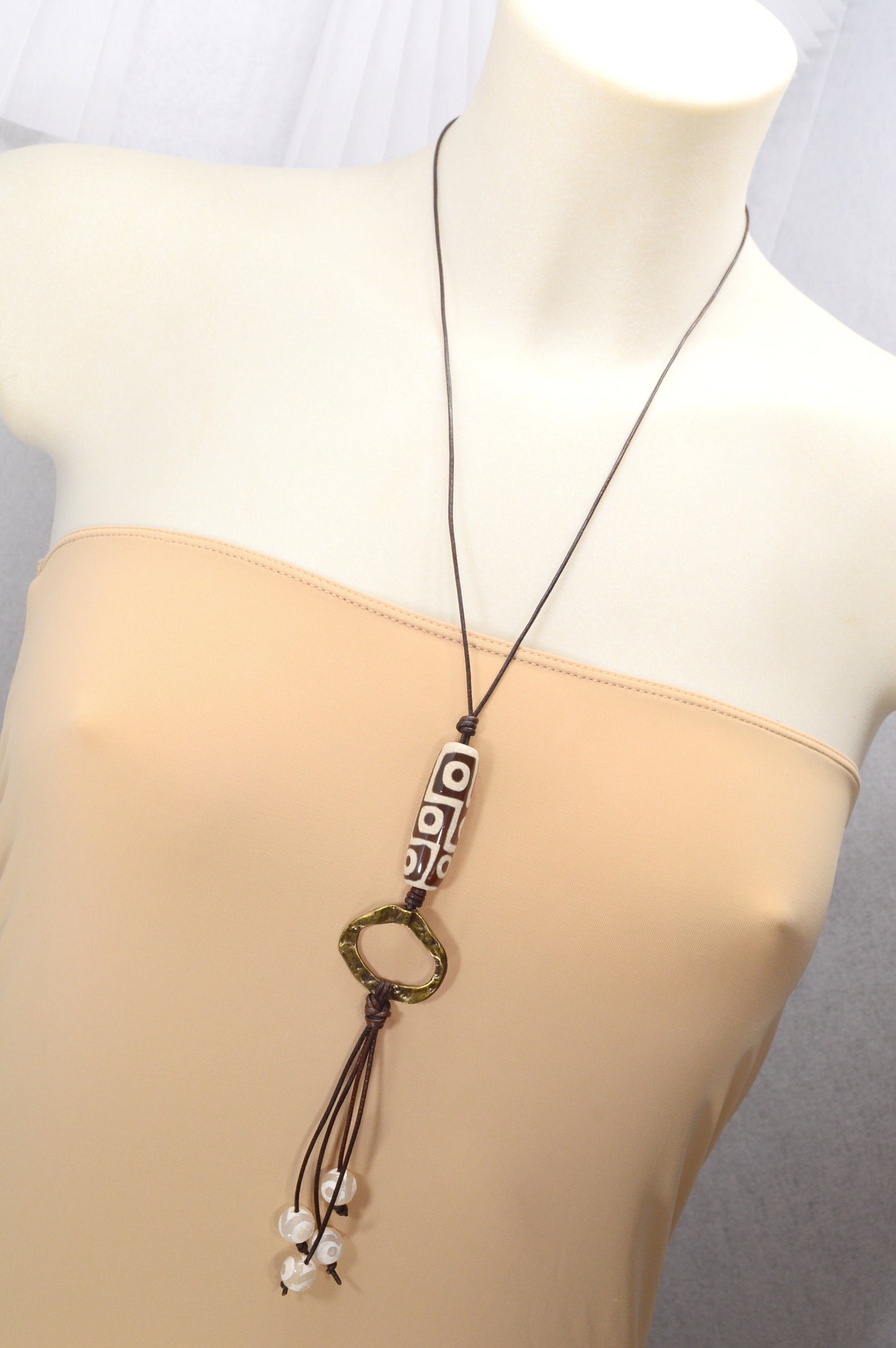 Long Leather cord necklace with agate DZI bead design, Artisan-crafted hippie Ring pendant, tribal-inspired. Estibela design.