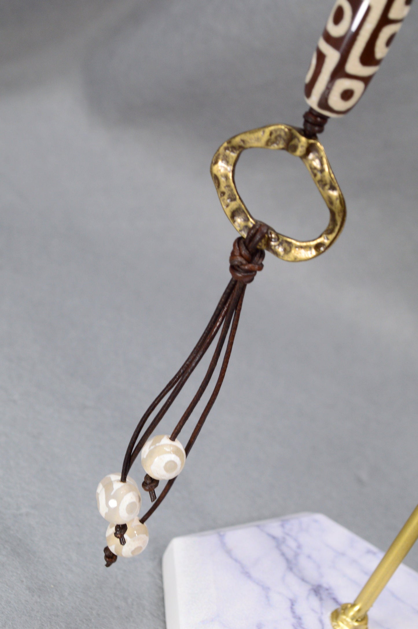 Long Leather cord necklace with agate DZI bead design, Artisan-crafted hippie Ring pendant, tribal-inspired. Estibela design.