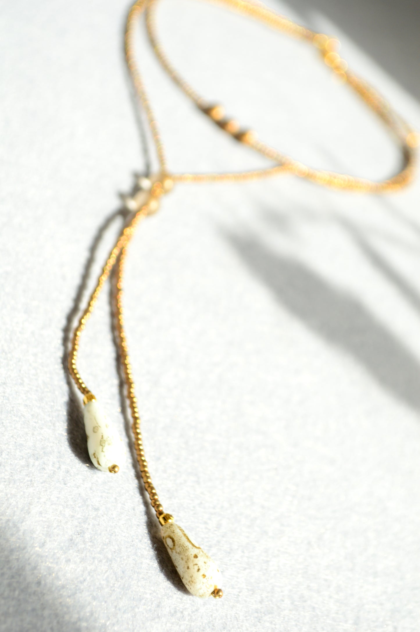 Gold Beaded Lariat Necklace with White Marble Glass Drops – Adjustable Minimalist Y Necklace