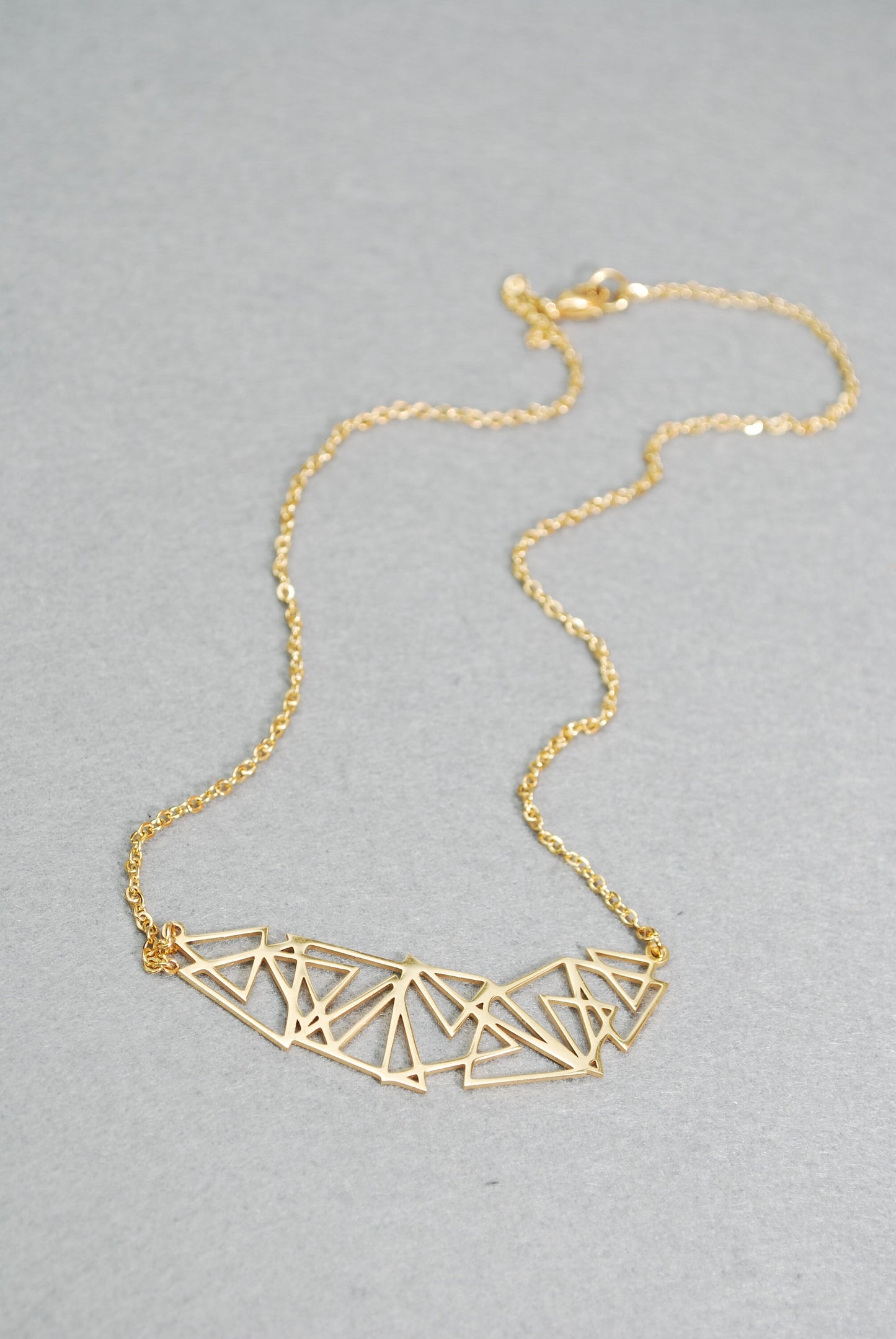 Stainless steel geometric abstract necklace, suitable for both casual and formal occasions. Makes a great gift idea.