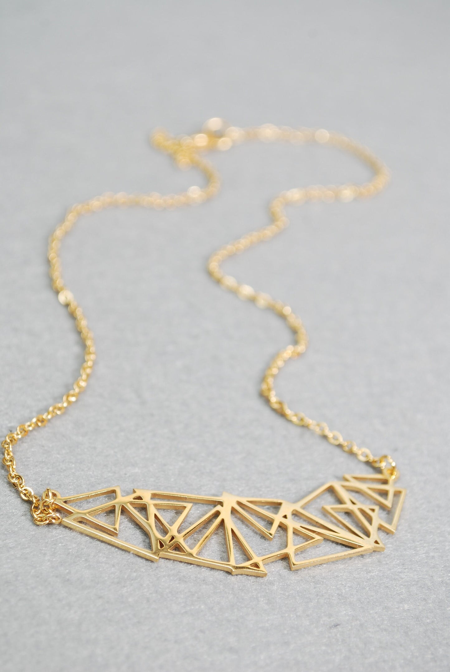 Stainless steel geometric abstract necklace, suitable for both casual and formal occasions. Makes a great gift idea.