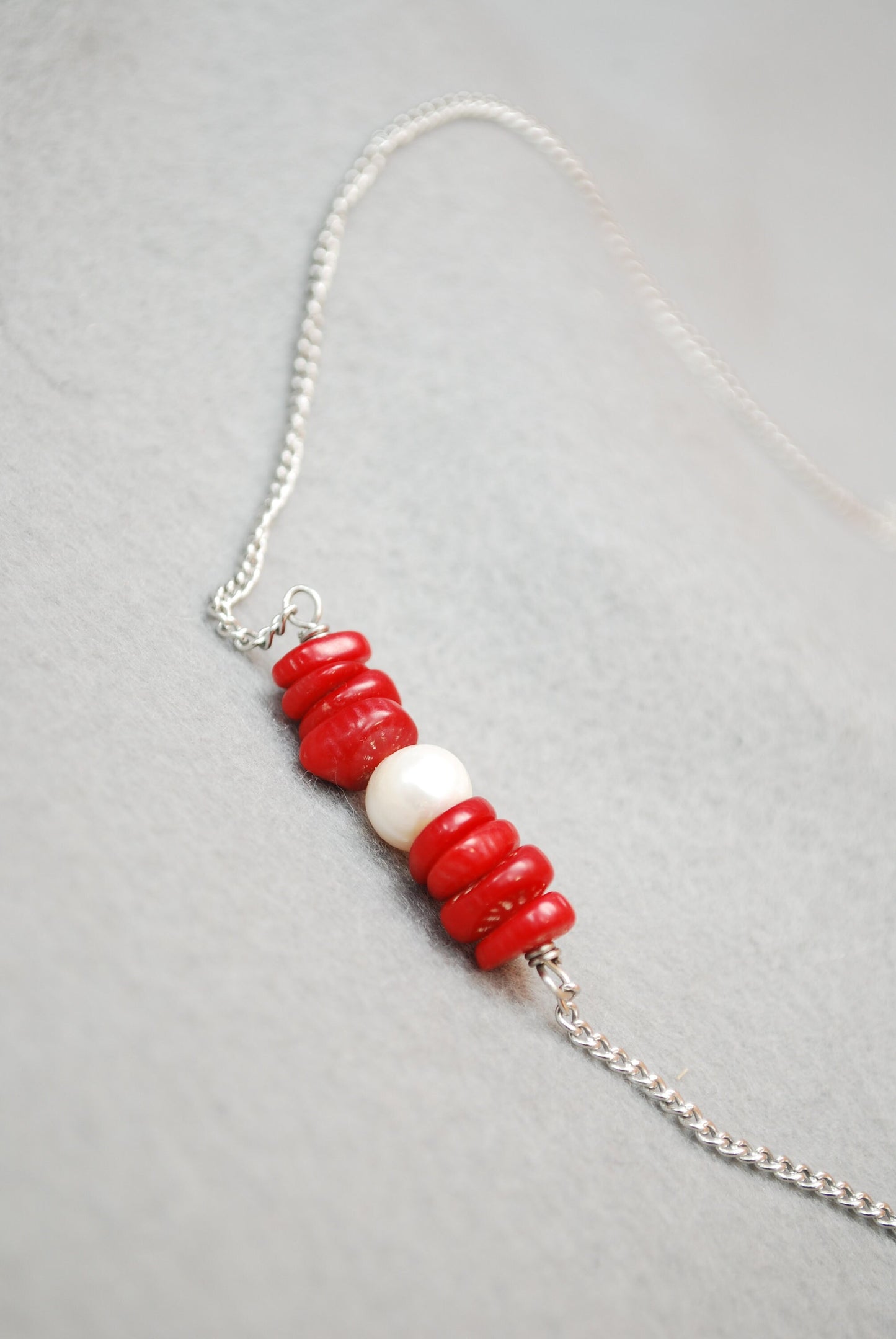 Ocean Breeze: Stainless Steel Necklace with Freshwater Pearl Center and Coral Stones. Estibela design.