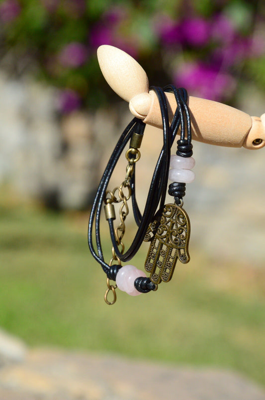 Black Leather Boho Bracelet with Bronze Hamsa Hand Charm and Natural Stone Decoration.