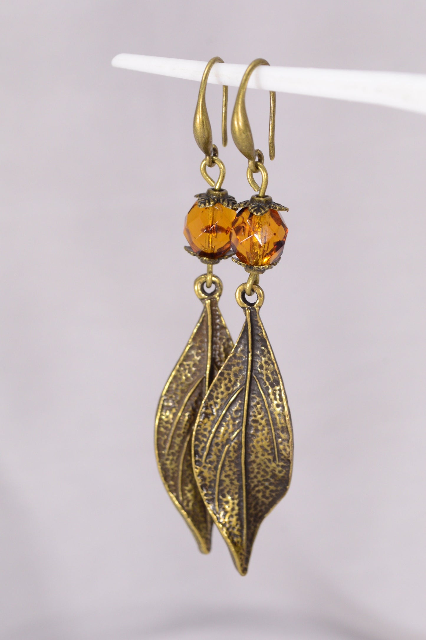 Bohemian Style Estibela Bronze Handmade Earrings with Dark Honey Czech Glass Bead and Twisted Leaf Pendant. 6.5cm - 2.4"