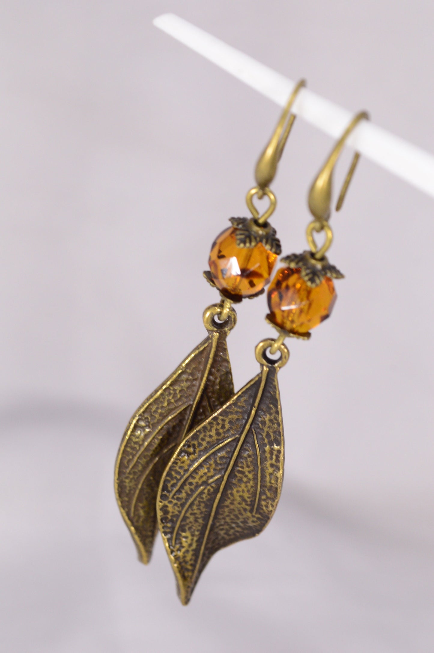 Bohemian Style Estibela Bronze Handmade Earrings with Dark Honey Czech Glass Bead and Twisted Leaf Pendant. 6.5cm - 2.4"