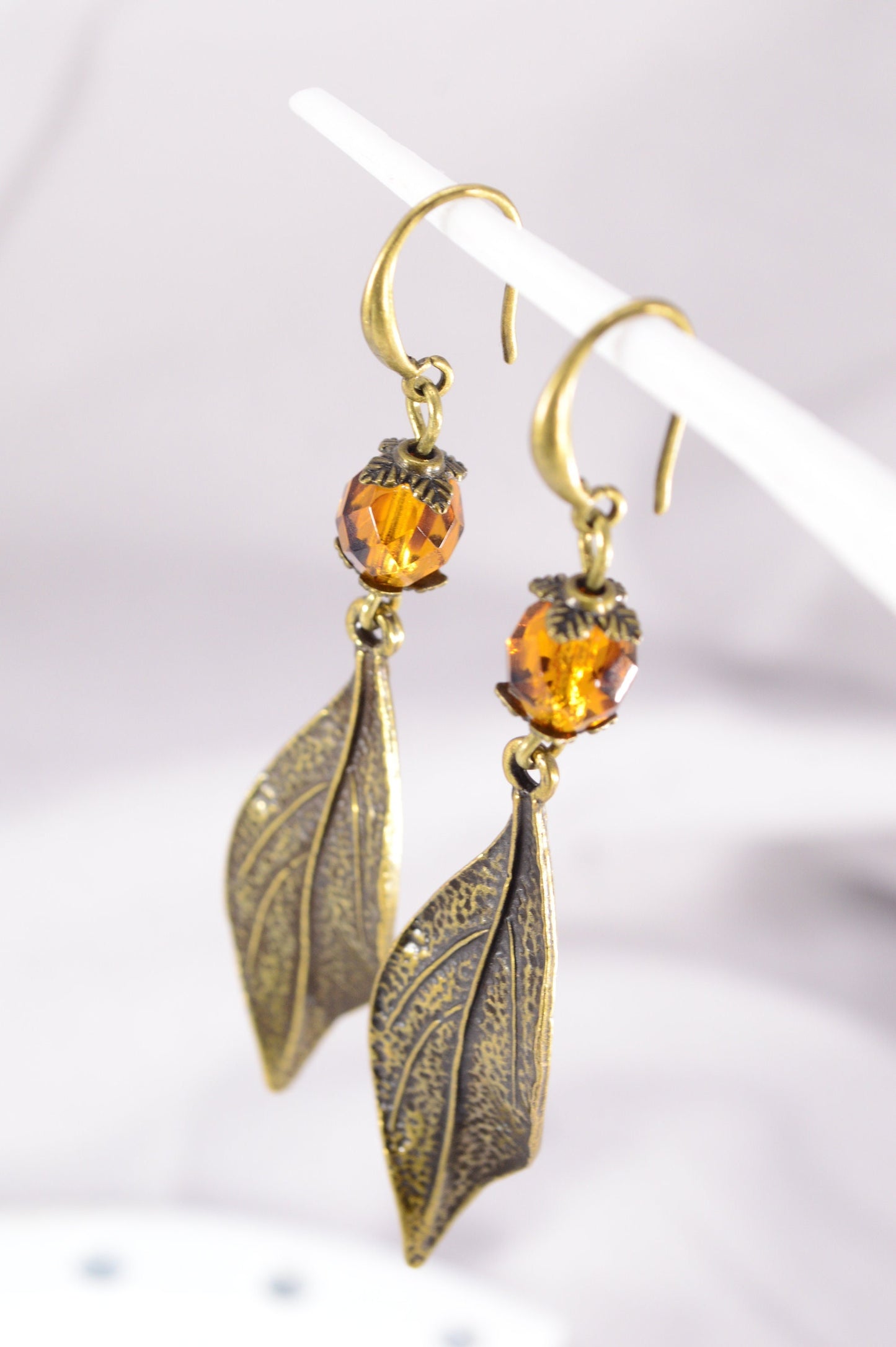 Bohemian Style Estibela Bronze Handmade Earrings with Dark Honey Czech Glass Bead and Twisted Leaf Pendant. 6.5cm - 2.4"