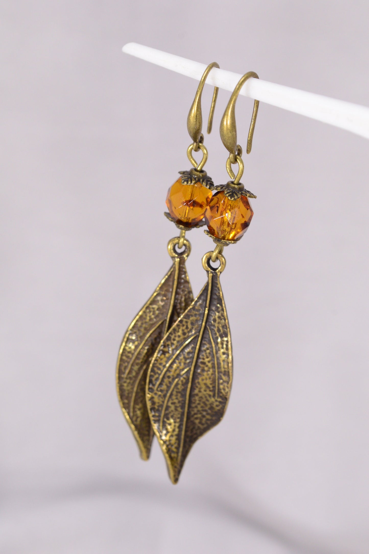 Bohemian Style Estibela Bronze Handmade Earrings with Dark Honey Czech Glass Bead and Twisted Leaf Pendant. 6.5cm - 2.4"