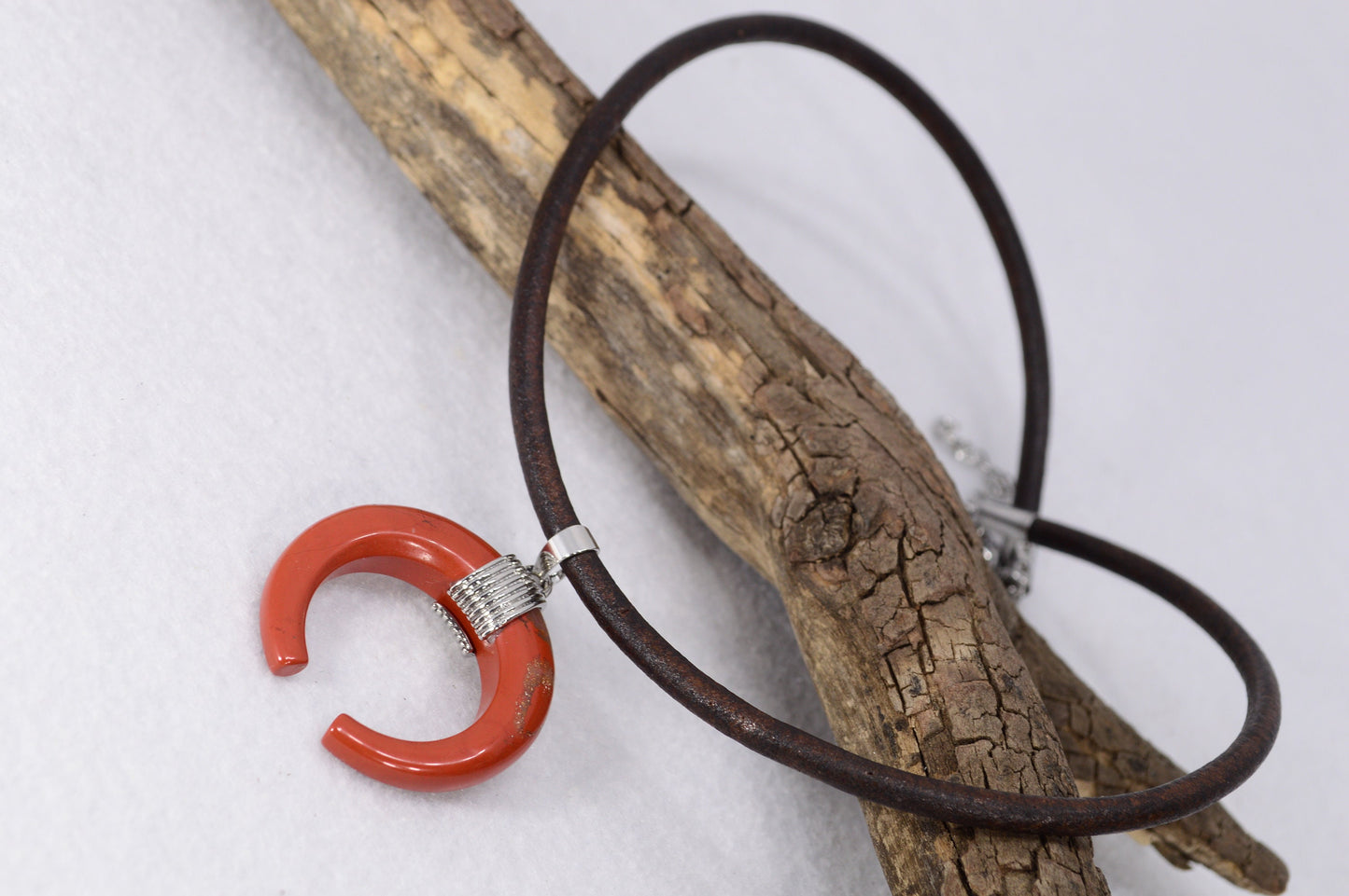 Estibela necklace with thick brown leather cord and moon-shaped pendant in Red Jasper or Blue Aventurine. Boho hippie design.