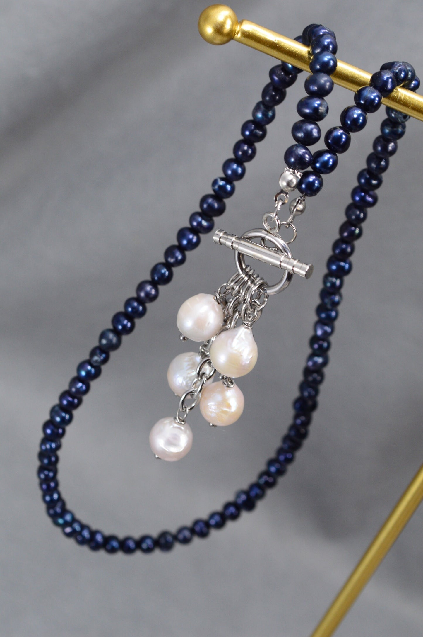 Dark blue freshwater pearl necklace with toggle clasp and baroque pearls,  unique Estibela design. Cascading baroque pearls pendant