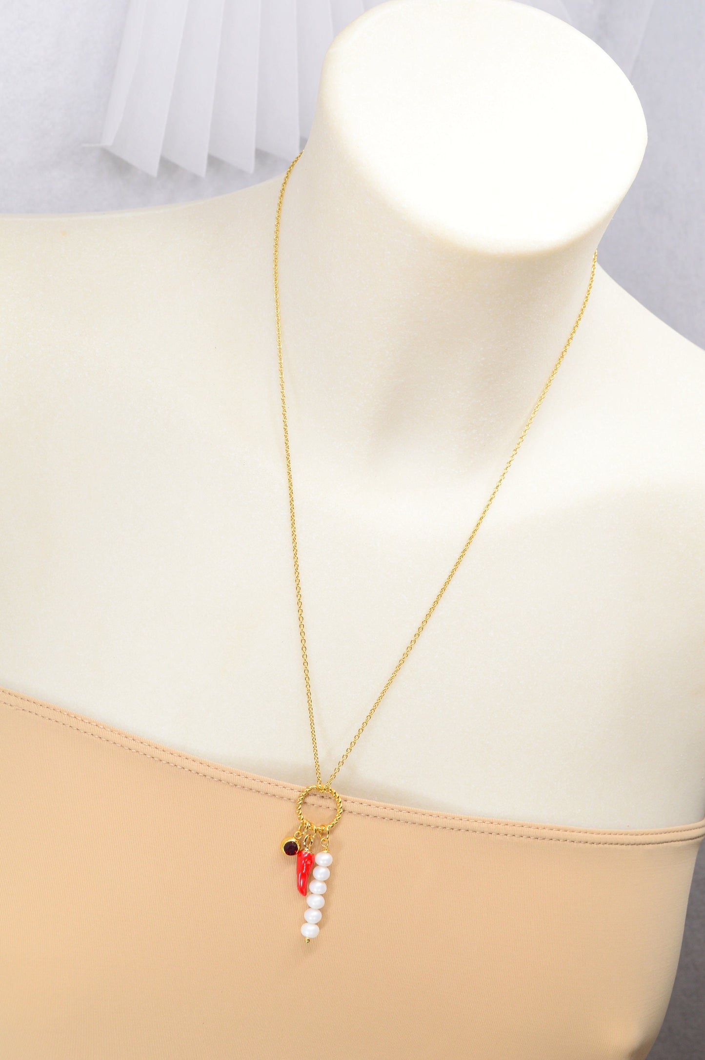 Red chili pepper necklace with gold stainless steel chain, red glass bead, and river pearls, perfect for edgy, boho-chic fashionistas