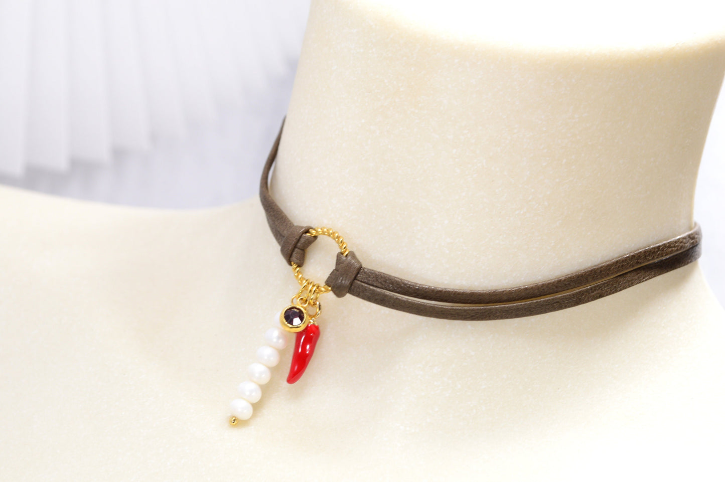 Red chili pepper pendant on this Estibela choker adds bold flair, complemented by a red glass bead and river pearls on soft leather.