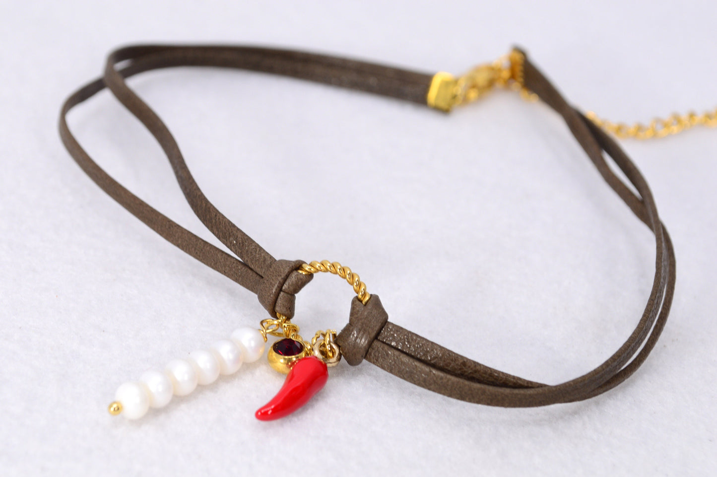 Red chili pepper pendant on this Estibela choker adds bold flair, complemented by a red glass bead and river pearls on soft leather.