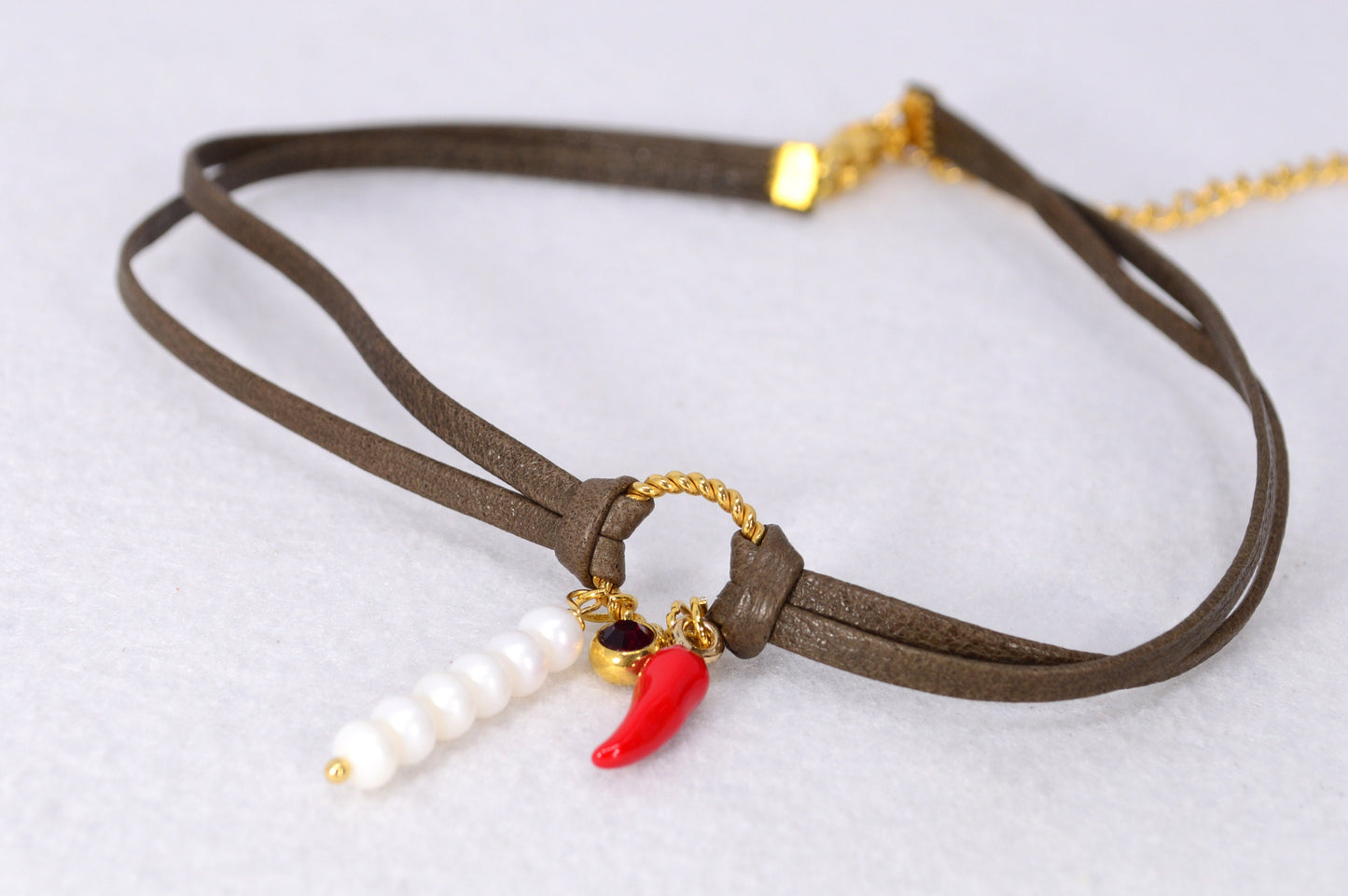 Red chili pepper pendant on this Estibela choker adds bold flair, complemented by a red glass bead and river pearls on soft leather.