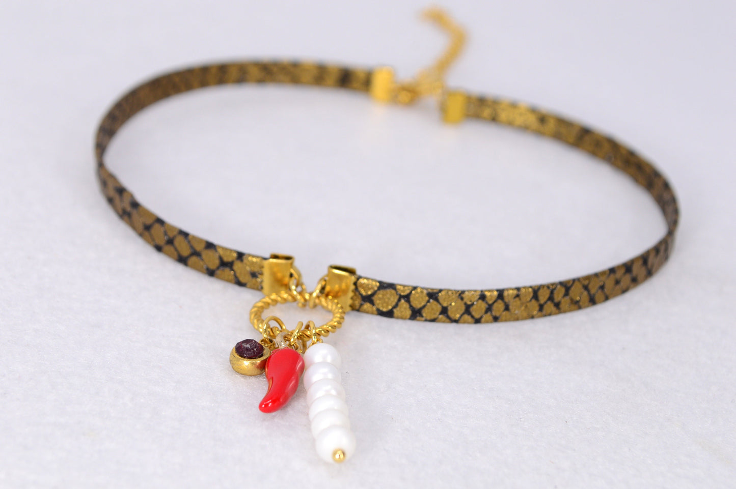 Fiery Serpent Choker: Golden Leather with Snake Skin Texture, Red Glass Bead, and Chili Pepper Pendant. Estibela unique design.