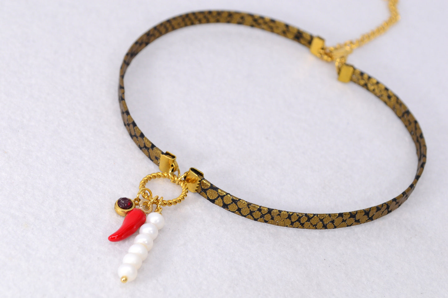 Fiery Serpent Choker: Golden Leather with Snake Skin Texture, Red Glass Bead, and Chili Pepper Pendant. Estibela unique design.