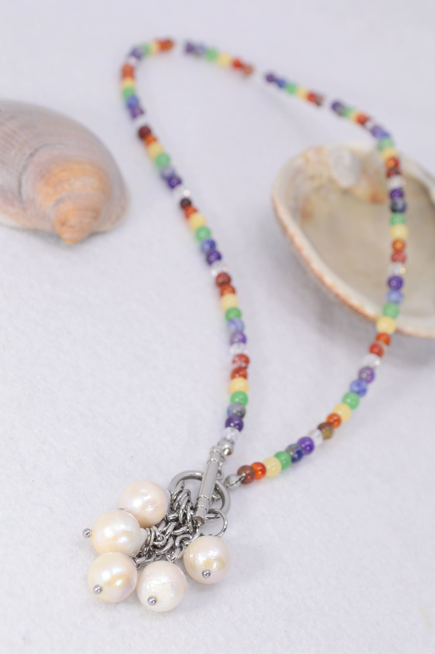 Pearl cascade necklace with chakra stones, offering a blend of boho chic and minimalist style. Toggle necklace. Estibela design.