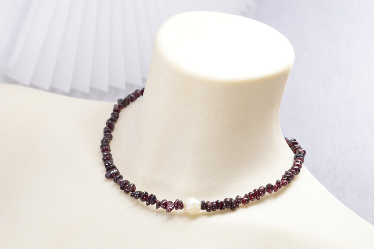 Garnet and stainless steel necklace with white baroque pearl, unique artisanal design perfect for elegant evening wear outings.