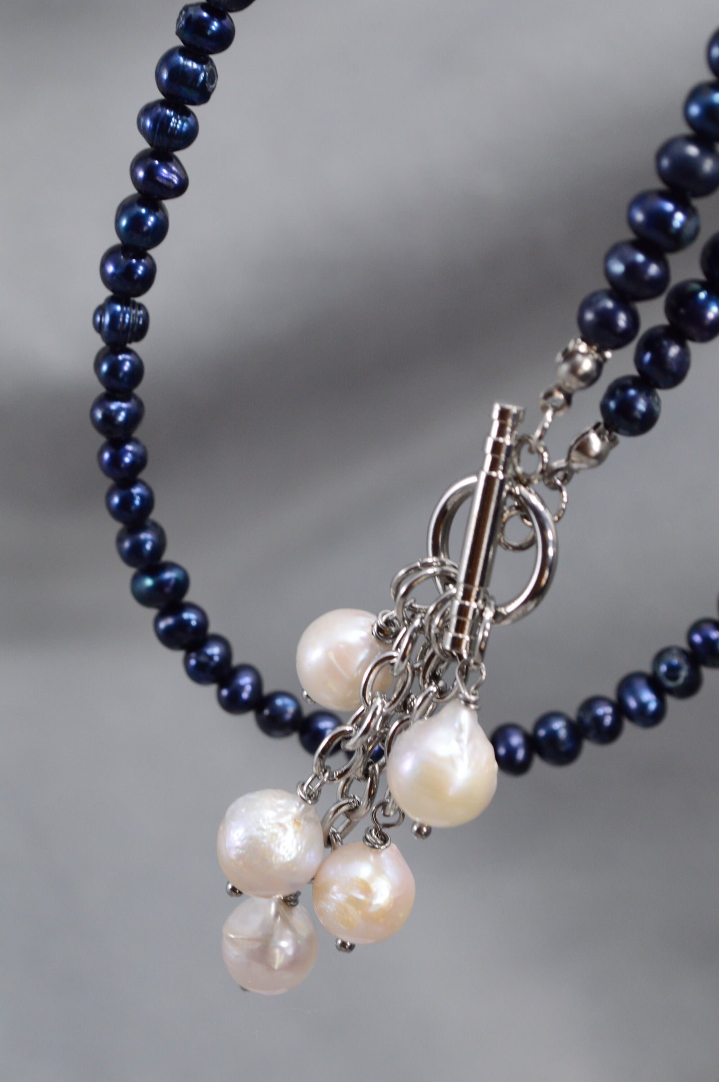 Dark blue freshwater pearl necklace with toggle clasp and baroque pearls,  unique Estibela design. Cascading baroque pearls pendant