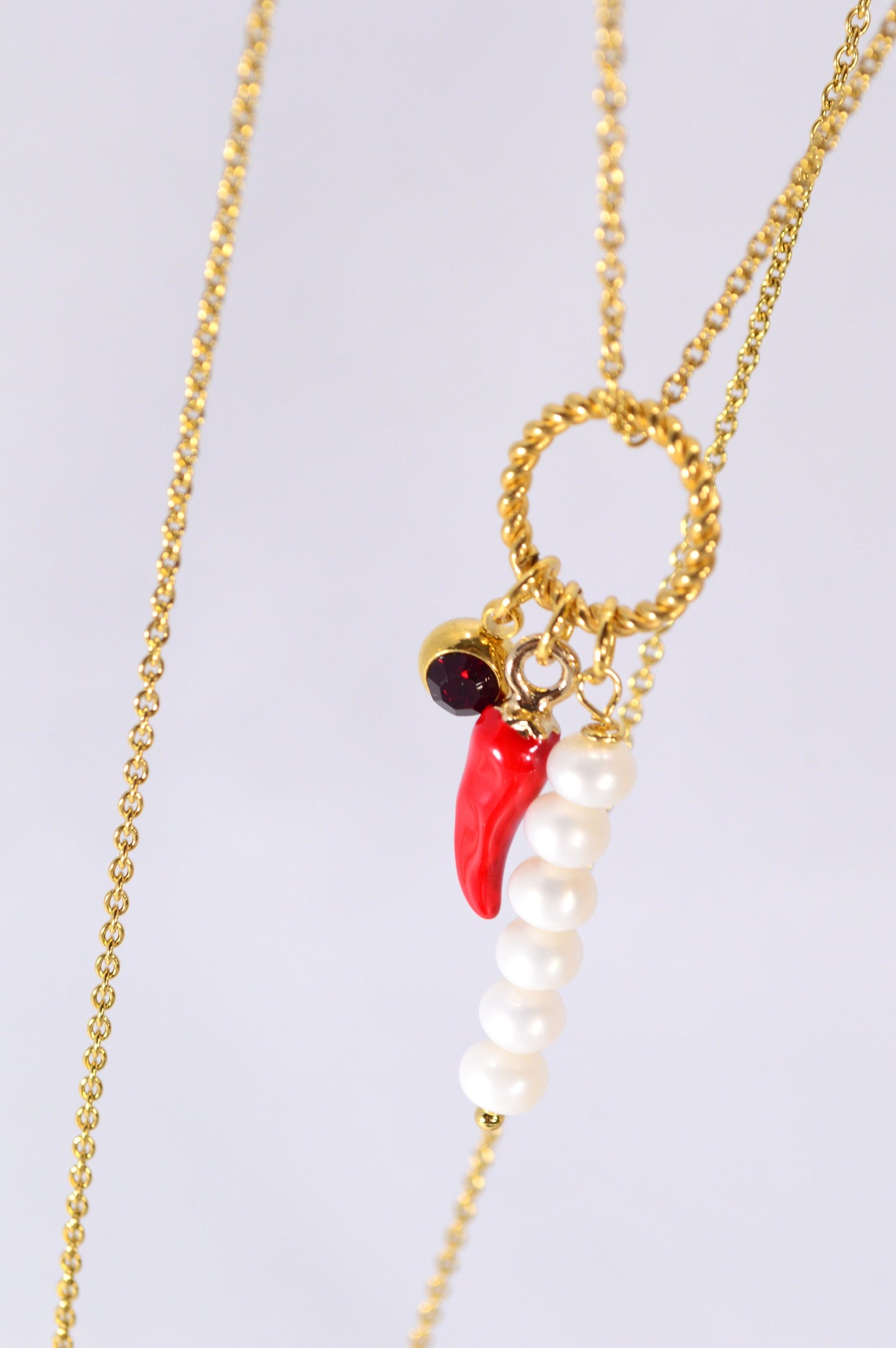 Red chili pepper necklace with gold stainless steel chain, red glass bead, and river pearls, perfect for edgy, boho-chic fashionistas