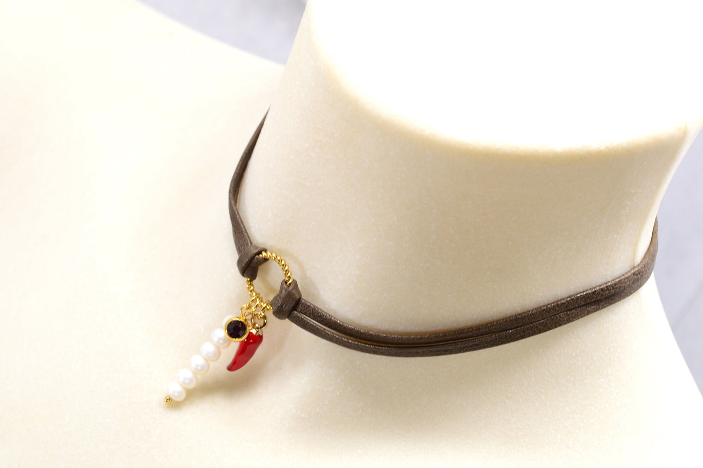 Red chili pepper pendant on this Estibela choker adds bold flair, complemented by a red glass bead and river pearls on soft leather.